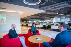 Staff sitting on couches around table